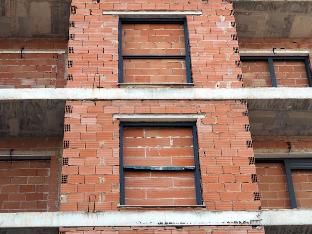 A multistorey building with brickwalled windows Hopelessness concept