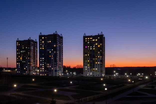 Multistorey buildings against the background of the sunset sky