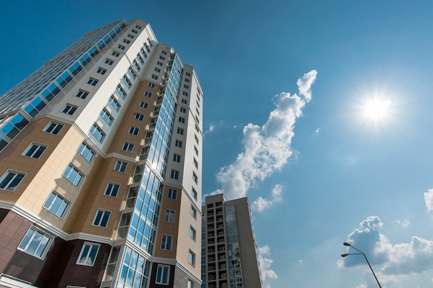 Multistorey residential house on blue sky background