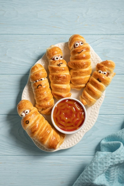 Mummy sausages scary halloween party food decoration wrapped in dough