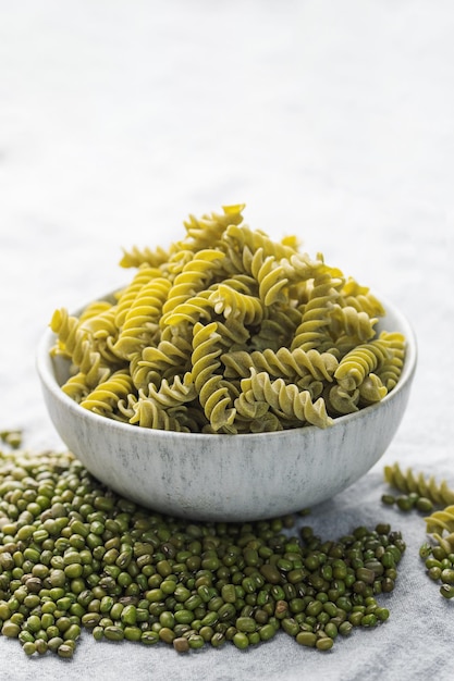 Mung bean fusilli pasta on a gray textile background