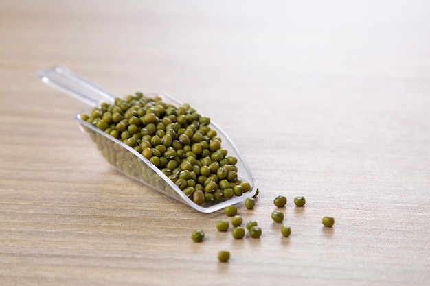 Mung bean in plastic spoon on wood table