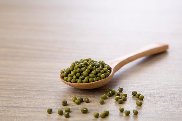 Mung bean in wood spoon on wood table