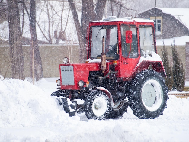 Municipal equipment removing snow from the footpaths in the city park after the snowfall. Weather in winter time