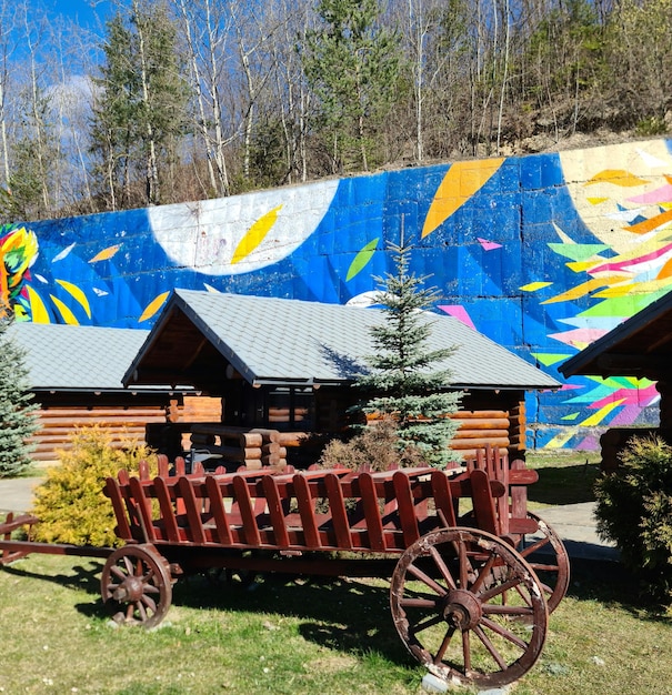 A mural on a wall with a wagon and a flower on it.