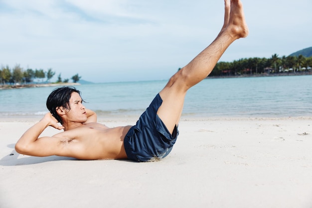 Muscular asian athlete exuding strength and freedom while running on the beach at sunset