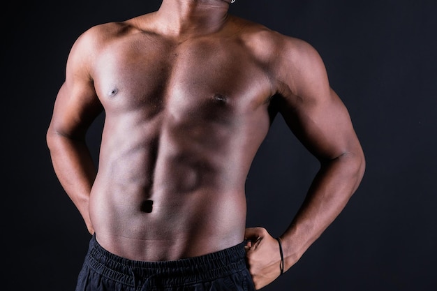 Muscular black african man with defined muscles abs abdominal exercise determination and success