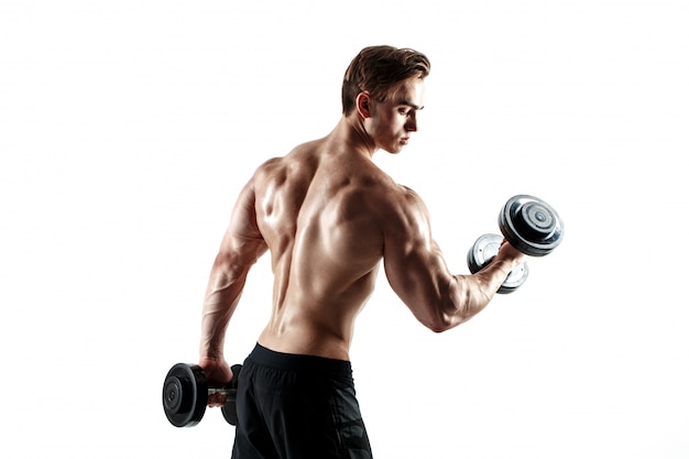 Muscular bodybuilder guy doing exercises with dumbbells over white background