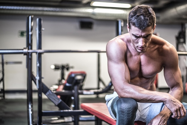 Muscular bodybuilder with towel