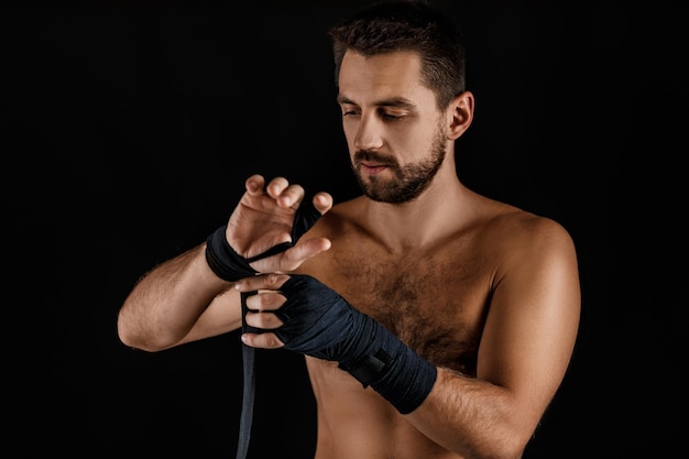 Muscular man boxer wearing black strap on wrist