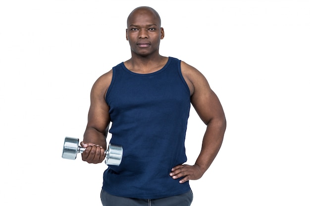 Muscular man exercising with dumbbell