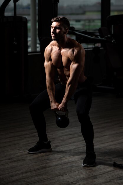 Muscular Man Exercising With Kettlebell