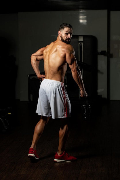 Muscular Man Resting After Exercise And Drinking From Shaker