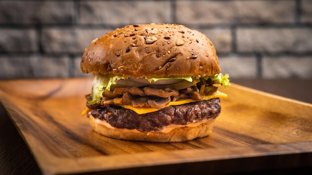 Mushroom beef burger isolated on wooden board side view on table fast food