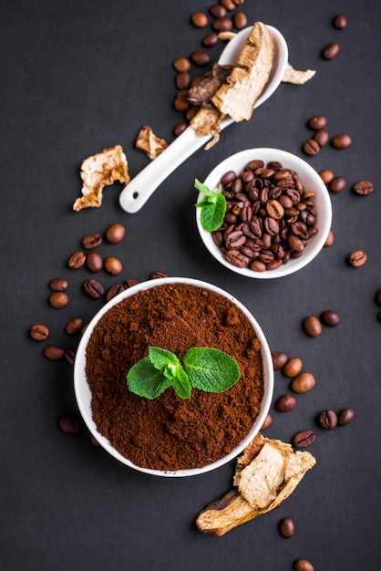 Mushroom Chaga Coffee Superfood Trend-dry and fresh mushrooms and coffee beans on dark surface with mint. Coffee break