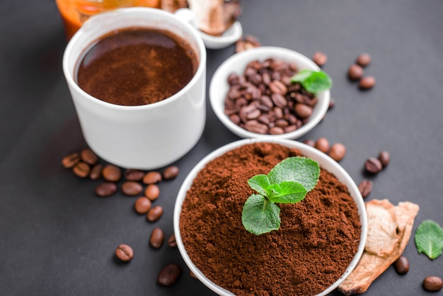 Mushroom Chaga Coffee Superfood Trend-dry and fresh mushrooms and coffee beans on dark surface with mint.