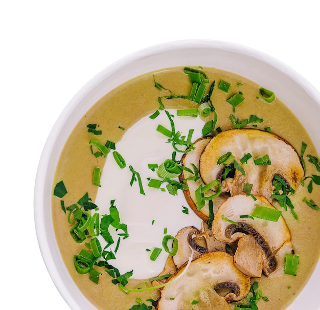 Mushroom cream soup in a bowl isolated on white background