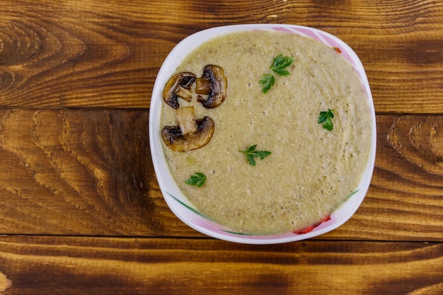 Mushroom cream soup on a wooden table Top view