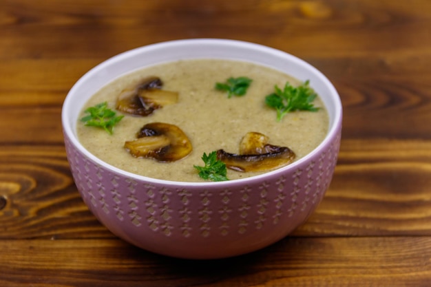 Mushroom cream soup on a wooden table