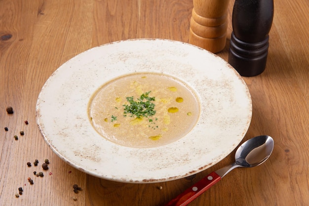 Mushroom cream soup on wooden table