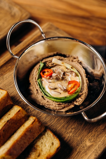 Mushroom pate in a plate with toast in restaurant table