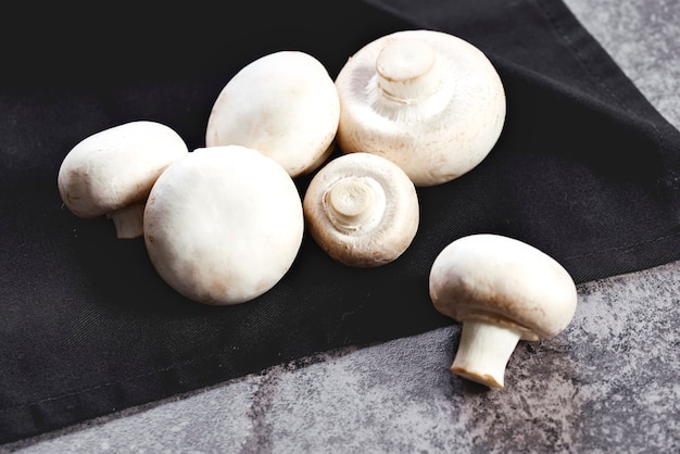 Mushrooms lying on the black kitchen towel