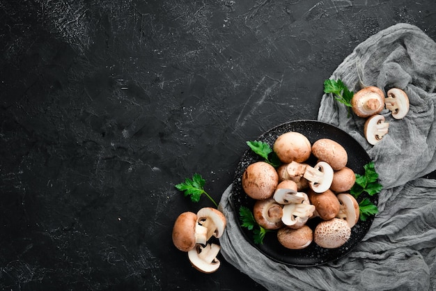 Mushrooms in a plate Champignons on the old background Top view Free copy space