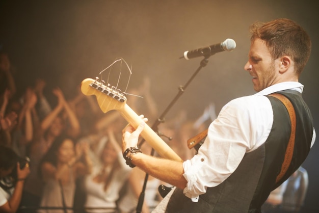 Music from the heart Shot of a frontman in a band singing on stage