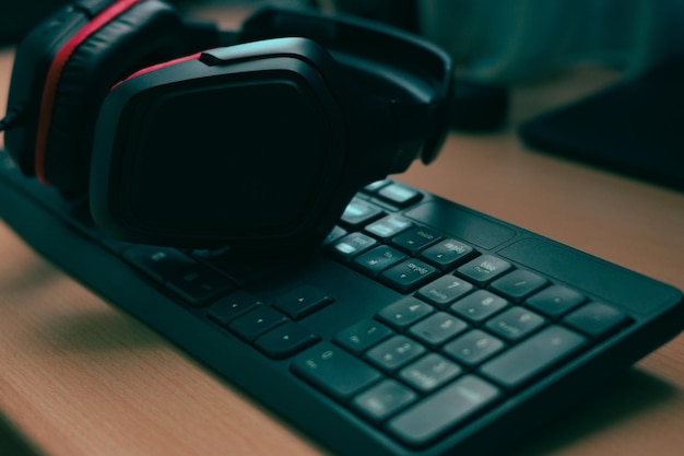 Music headphones and a computer keyboard on a desk