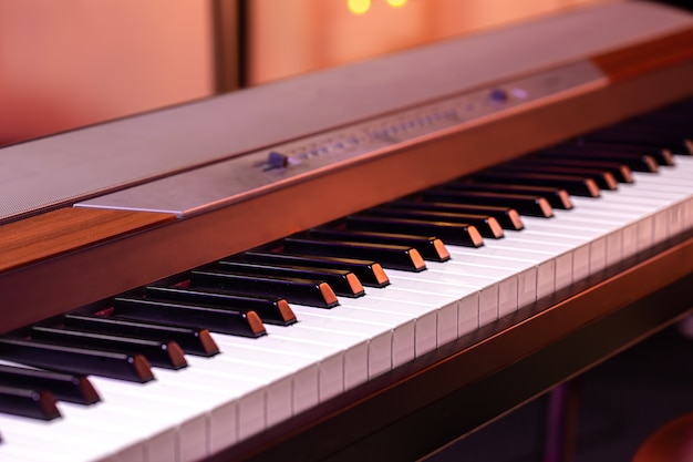 Music keys under colored lighting on a blurred background.