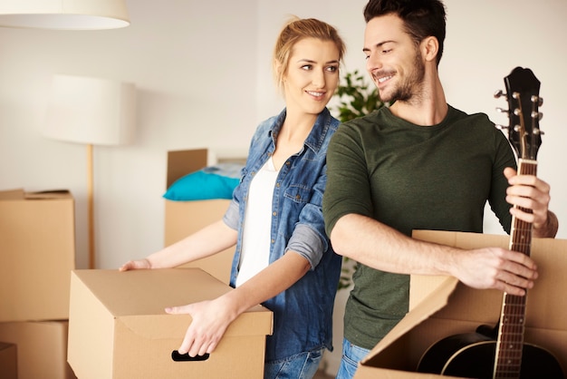 Music lover unpacking equipment in new house