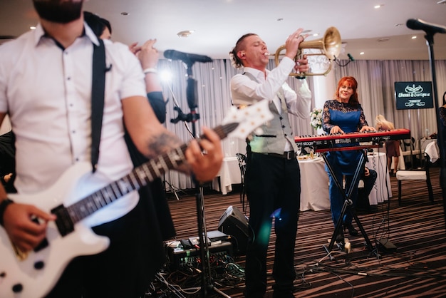 Musical group, band, on stage in bright rays