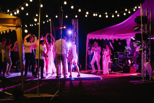 Musical group, band, on stage in bright rays