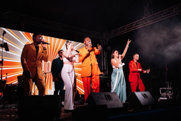 Musical group, band, on stage in bright rays