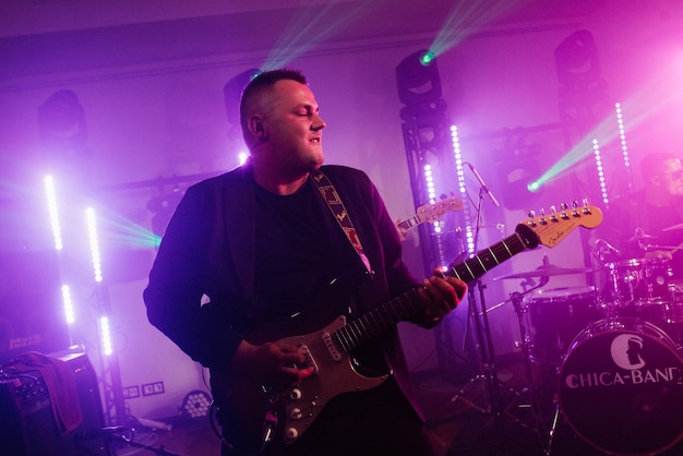 Musical group, band, on stage in bright rays