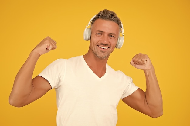 Musical strength workout Fit melomane flex arms listening to music Sound technology Stereo headphones Modern lifestyle Having musical bone in body