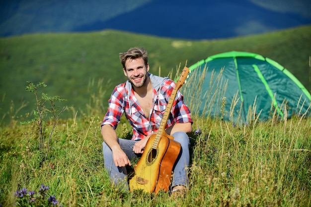 Musician looking for inspiration Summer vacation highlands nature Dreamy wanderer Pleasant time alone Peaceful mood Guy with guitar contemplate nature Wanderlust concept Inspiring nature