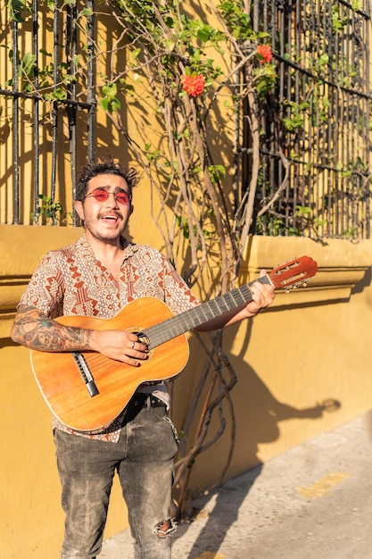 Musician playing guitar standing on the street