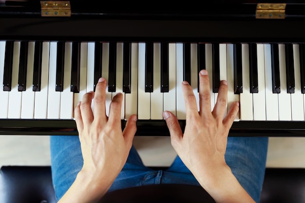 Musician playing piano performing at concert stage