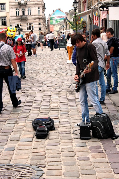 Musician plays guitar in the central street of Lvov