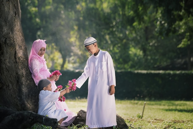 Muslim boys and girls are having fun playing under the trees Beside the old mosque in Ayutthaya Thailand