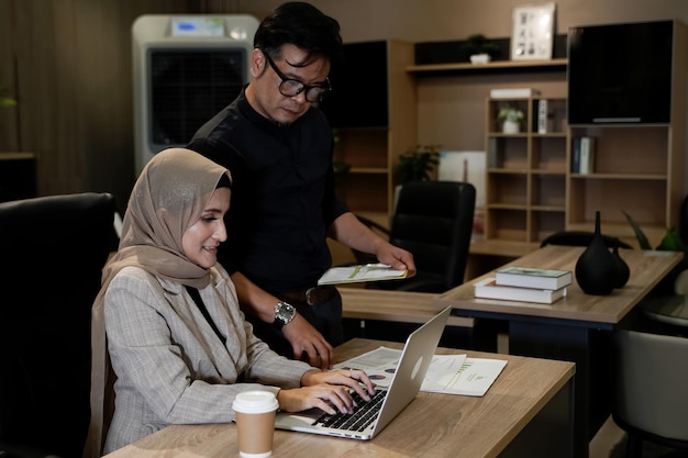 Muslim business man and woman busy with documents and laptop in modern office business concept