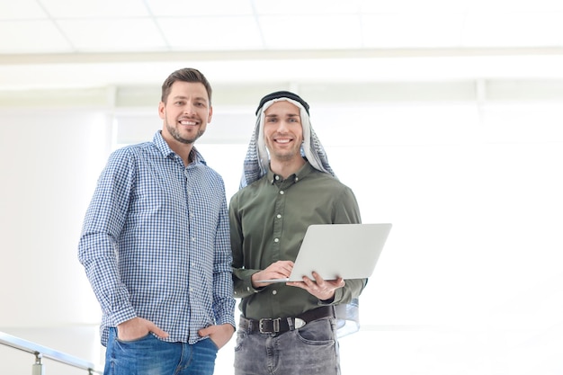 Muslim businessman with coworker in office