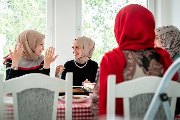 Muslim family and friends gathering together at home for eating dinner high quality photo