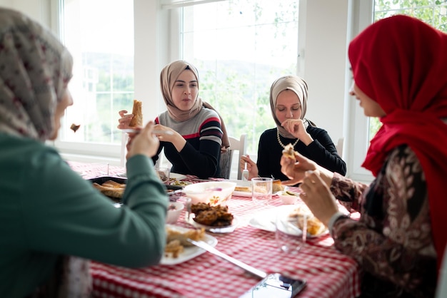 Muslim family and friends gathering together at home for eating dinner high quality photo