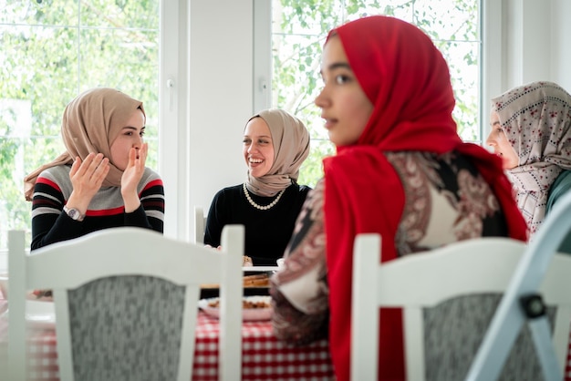 Muslim family and friends gathering together at home for eating dinner high quality photo