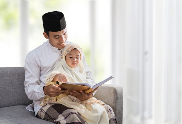 Muslim father read quran with his daughter