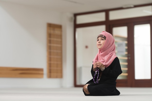 Muslim Girl In Headscarf Is Holding Rosary