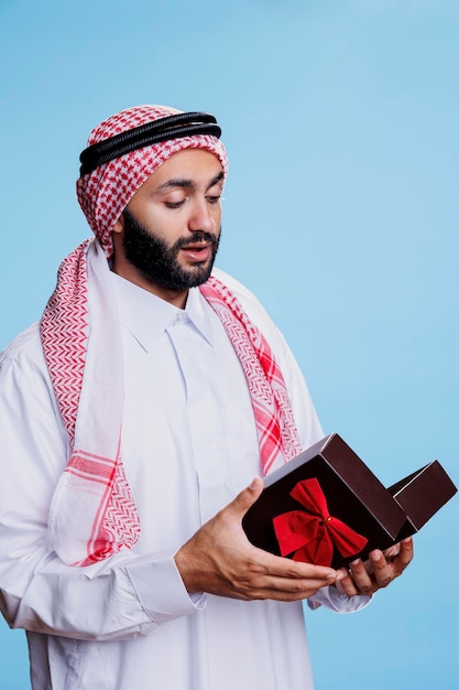 Muslim man opening present giftbox