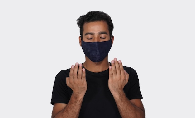 Muslim Man praying to allah Wearing mask